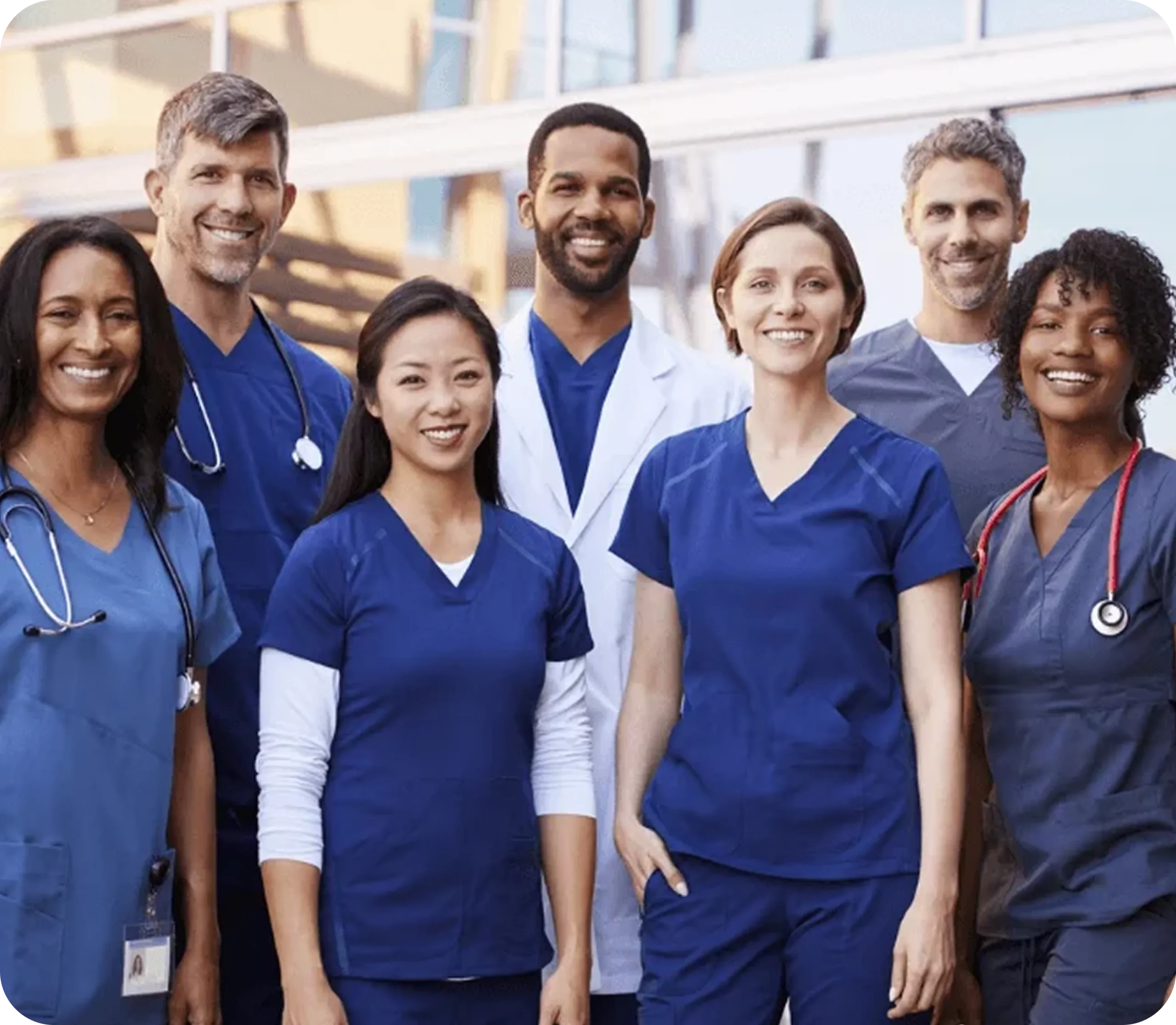 Diverse group of healthcare professionals wearing medical scrubs, representing collaborative clinical teams and healthcare partnerships.